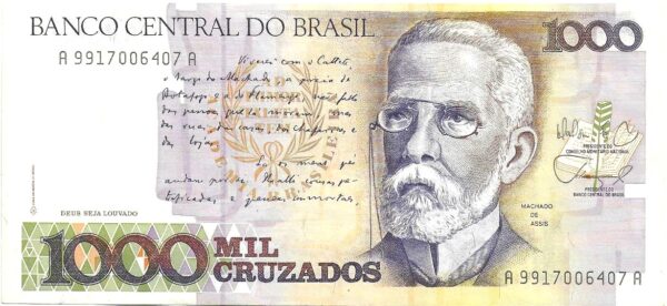 Br Cédula mil Cruzados (1986-1989). (S). Calcografia em cor violeta, efígie de Machado de Assis. Impressão Casa da Moeda do Brasil. Verso: Calcografia; vista da rua 1º de Março no Rio de Janeiro na cor violeta.